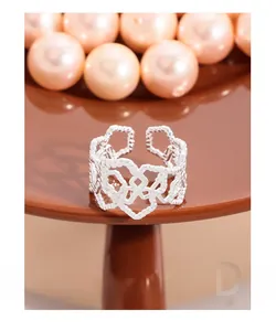 Close-up of S925 sterling silver hollow heart ring on a round pedestal display