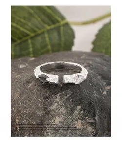 Macro detail of S925 silver snake-texture ring with black and white zircon gems