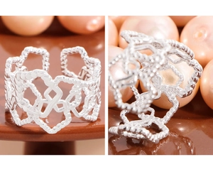 Detailed macro of S925 sterling silver ring with hollow hearts and twisted texture