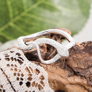 S925 sterling silver snake ring with scale texture on natural wood bark background