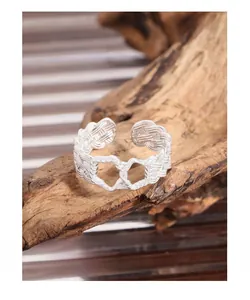Macro detail of S925 sterling silver twisted woven ring with interlocking hearts design