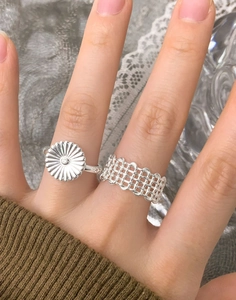 Detailed macro view of S925 sterling silver daisy ring and hollow woven mesh band ring