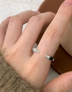Close-up of S925 silver ring featuring black and white marquise zircons on hand