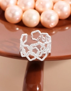 Detailed macro view of S925 silver hollow heart-shaped twisted texture ring