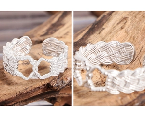 Close-up of S925 sterling silver stamp on a twisted woven hollow heart ring