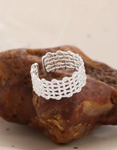 Detailed close-up of S925 sterling silver layered woven mesh ring on a natural stone