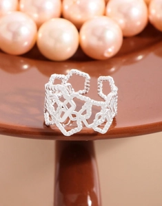 Detailed close-up of S925 silver hollow geometric ring on a pedestal with pearls