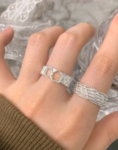 Detail of S925 sterling silver hollow heart and braided multi-layer stackable rings