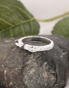 Detail of S925 silver stamp and marquise-cut zircon on the textured ring band