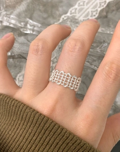 Close-up of S925 sterling silver multi-layer woven mesh ring on finger in a refined style