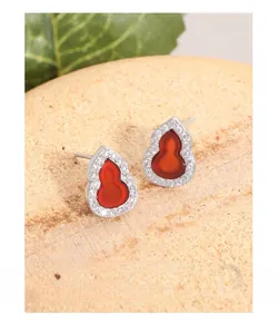 Macro shot of S925 silver gourd earrings with red carnelian and cubic zirconia pavé