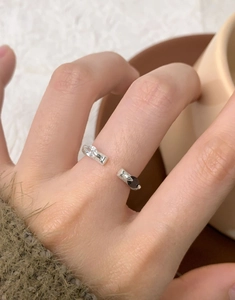 Macro detail of S925 silver open ring featuring black and white teardrop zircons