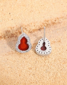 Macro detail of S925 hallmark on silver gourd stud earring with red carnelian and zircon
