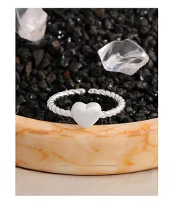 Macro shot of S925 sterling silver twist ring with a matte frosted heart detail
