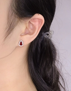 Macro detail of S925 silver gourd earring with red agate inlay and zircon stones