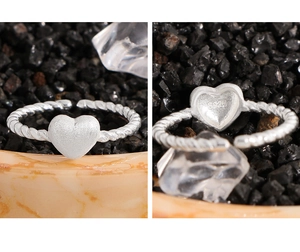 Detail of S925 sterling silver stamp on twisted band matte heart ring