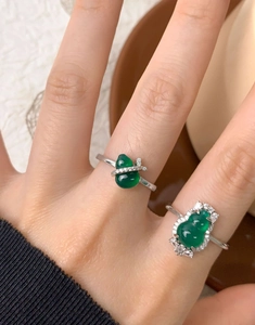 Macro detail of S925 silver rings with green chalcedony gourd and zircon on model hand
