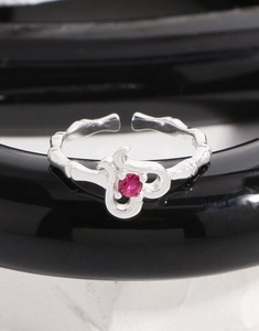 Macro shot of S925 silver ring featuring a rose red zircon and bamboo style band