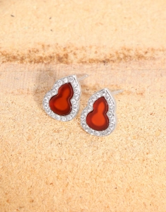 Macro shot of silver stud earring featuring red carnelian Wulu shape and pavé zircon stones