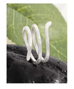 Detail of S925 sterling silver snake ring with textured brushed hammered finish