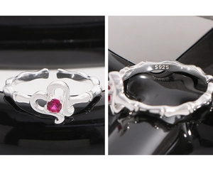 Detailed view of S925 sterling silver stamp and red zircon heart ring texture