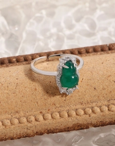 Detailed macro of S925 silver ring with green chalcedony gourd and zircon inlay