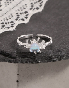 Macro detail of S925 silver lava texture ring featuring a glowing moonstone