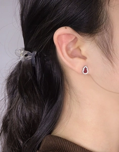 Close-up of S925 silver red carnelian wulu stud earrings with sparkling zircon on ear