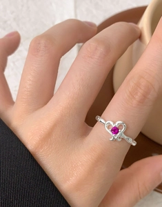 Macro shot of S925 silver irregular heart ring with a vibrant rose red zircon gemstone
