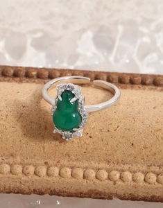 Macro shot of silver ring featuring green chalcedony gourd with sparkling cubic zirconia