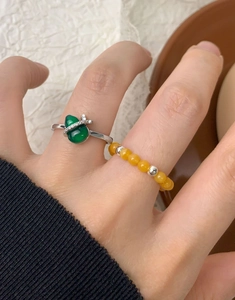 Detail of S925 silver ring with green chalcedony gourd and yellow beaded elastic ring