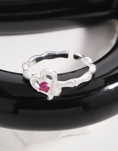 Close-up of S925 sterling silver heart ring featuring pink zircon and bamboo texture band
