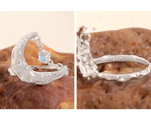 Macro detail of S925 sterling silver stamp and lava texture moon ring with moonstone