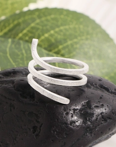 Macro detail of S925 sterling silver snake texture ring on natural stone background