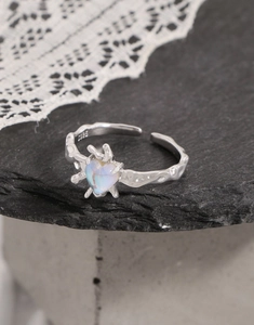 Macro view of S925 silver lava texture ring featuring a heart-shaped opal stone