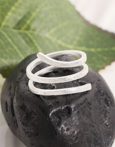 Detailed macro view of S925 silver ring with hammer texture on black stone and leaf