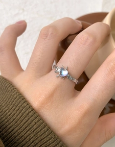 Detail of S925 silver lava texture heart moonstone ring worn in a cozy setting