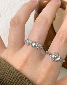 Detail of S925 silver lava texture heart ring and moonstone band on finger