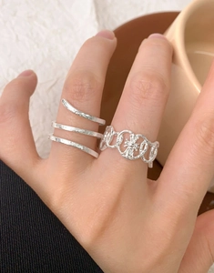 Detail of S925 silver textured snake-skin open rings with vintage hammer pattern