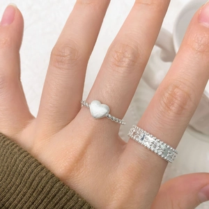 Minimalist S925 sterling silver heart ring and twisted rope band worn on finger