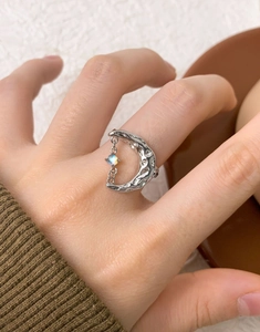 Close-up of S925 sterling silver crescent moon ring with iridescent gemstone on hand