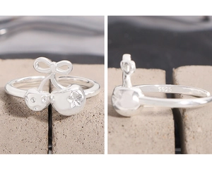 Detailed close-up of S925 silver ring featuring bow and cherry designs with inner hallmark