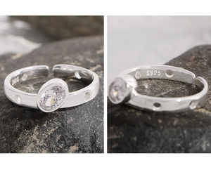 Macro detail of S925 sterling silver ring with oval zircon and hollow geometric design