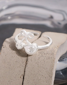 Detailed macro of S925 sterling silver bow cherry open ring with zircon accents