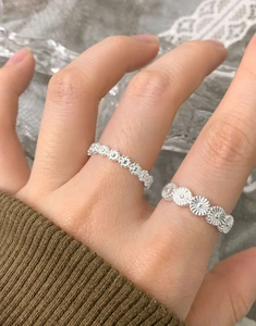 Detailed view of S925 sterling silver rings with floral and sun flower patterns