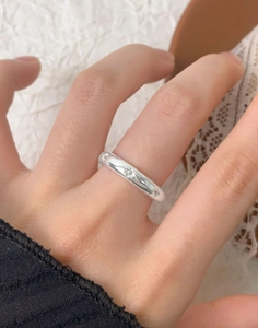 Close-up of S925 sterling silver star ring on model with elegant lifestyle background