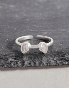 Macro view of S925 sterling silver wave ring with matte texture on stone background