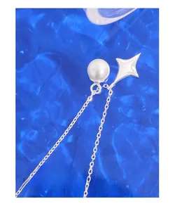 Macro shot of silver star pendant and white pearl with an elegant rippled blue background