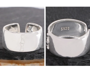 Detailed close-up of S925 sterling silver wide ring with double bow engraved patterns