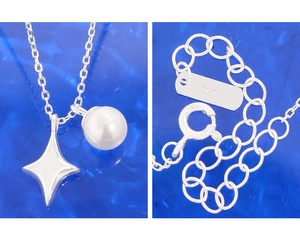 Detailed macro of S925 sterling silver star and pearl pendant with lobster clasp